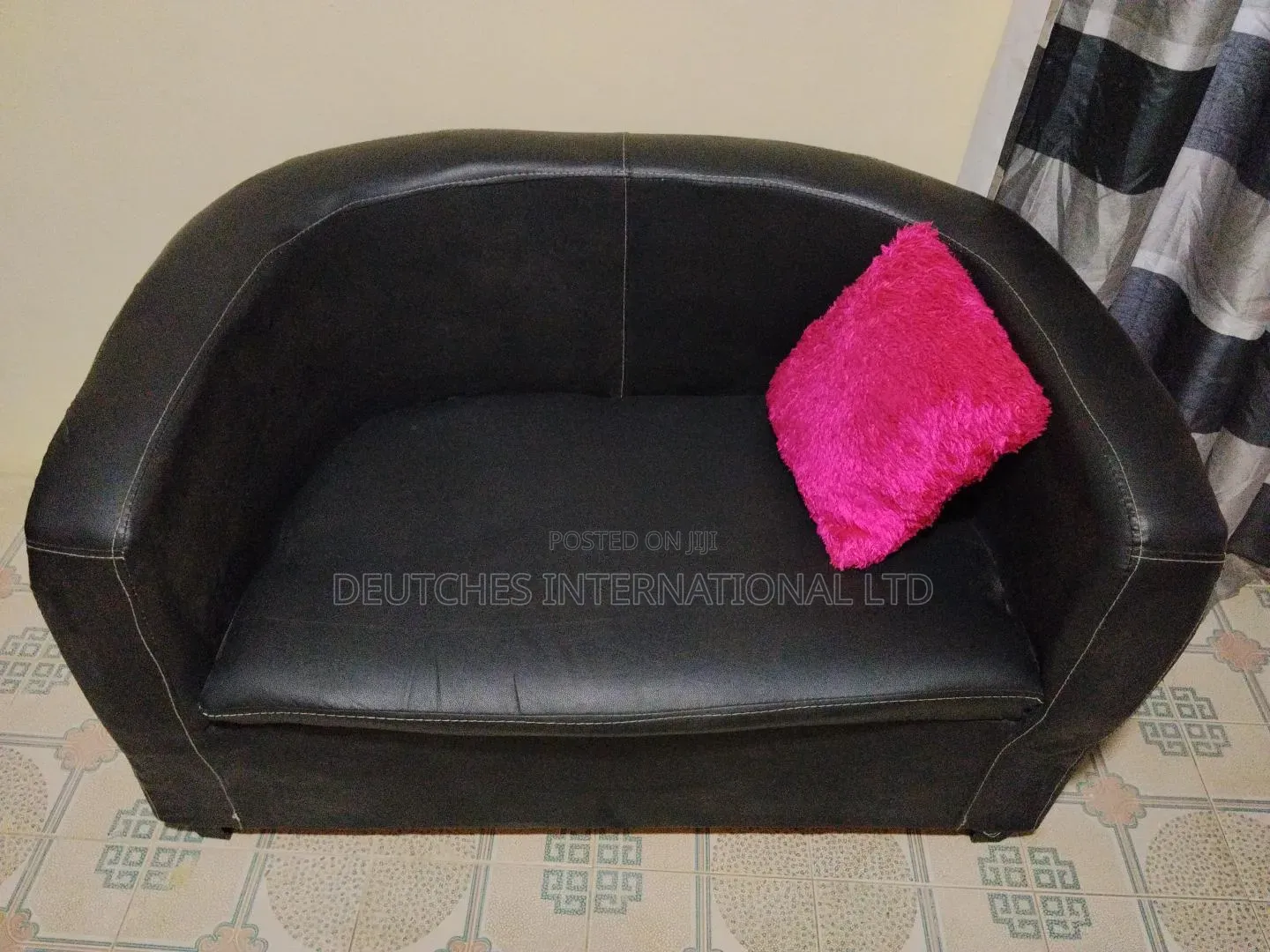 Black Leather Two-Seater Sofa – Fairly Used, Negotiable