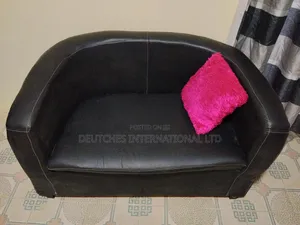 Black Leather Two-Seater Sofa – Fairly Used, Negotiable
