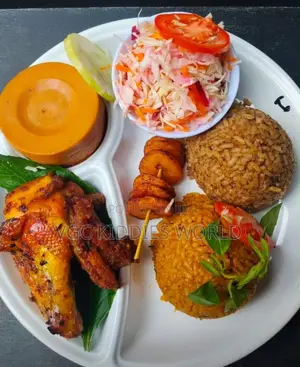 Food Plate of Rice, Salads, Moi Moi Chicken Well,very Well Presented