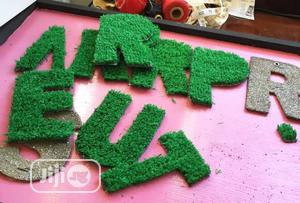 We Create Alphabet With Green Grass Rugs