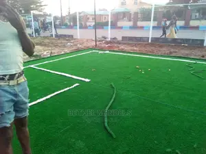 Installation Of Astro Turf Grass On Football Field