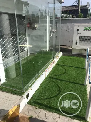 Decoration Of Your Show Room Entrance With Green Grass Rugs