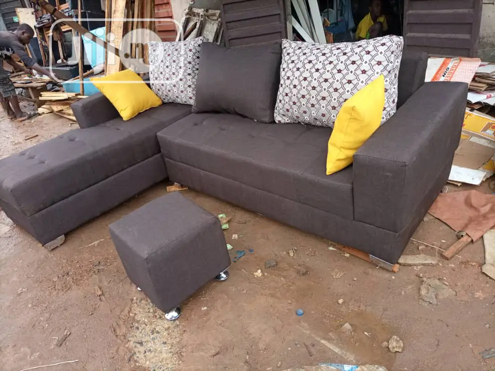 Brown L- Shaped Sofa With Ottoman