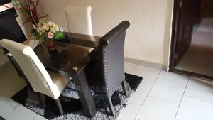 Dining Set of 4 Chairs and a Glass Table. Leather