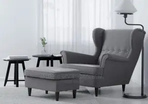 Ash Colored Relaxing Chair and a Pad Center Table Like Puff